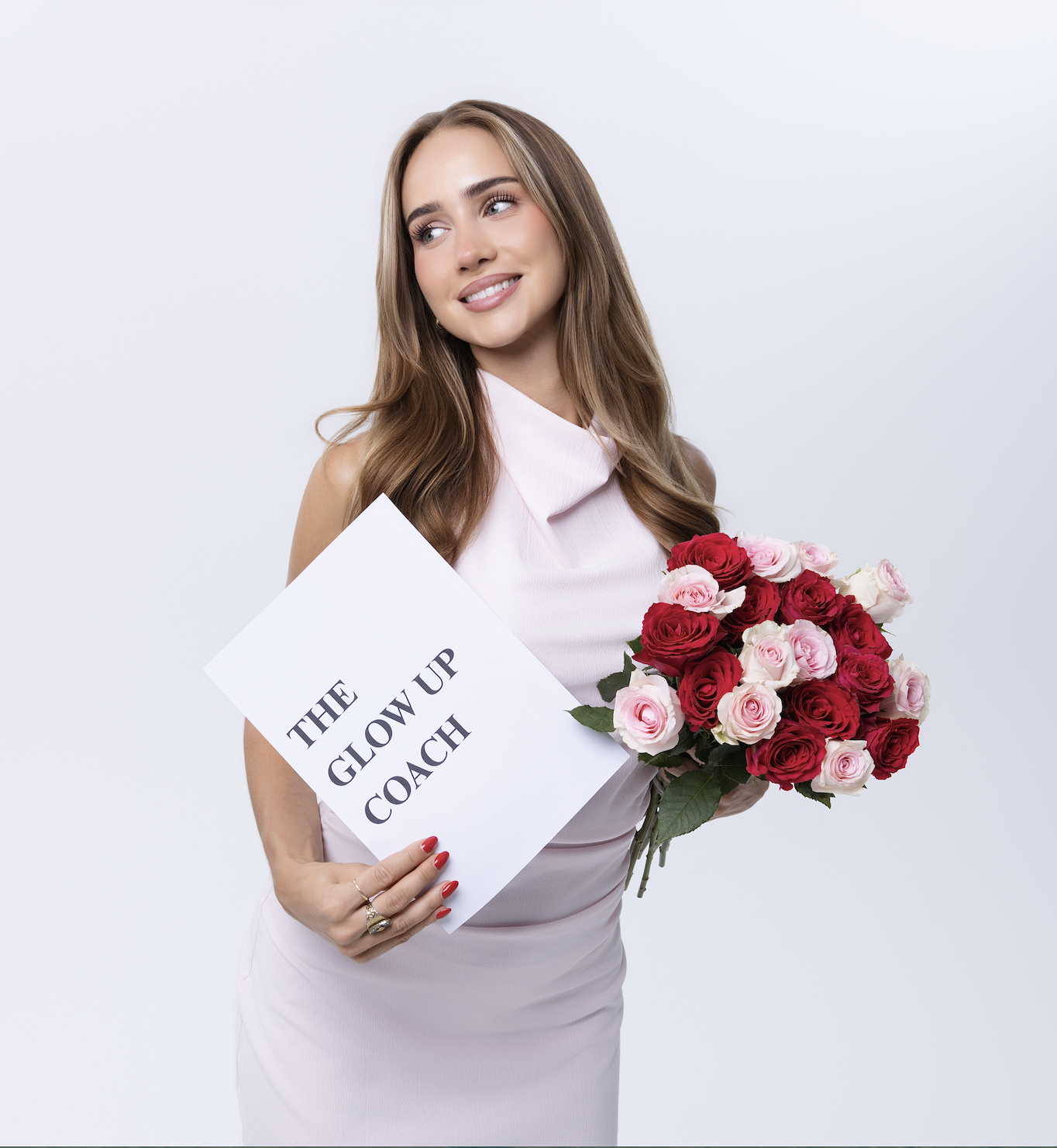 Julia, founder of The Glow Up Coach, holding a sign that reads 'The Glow Up Coach'
